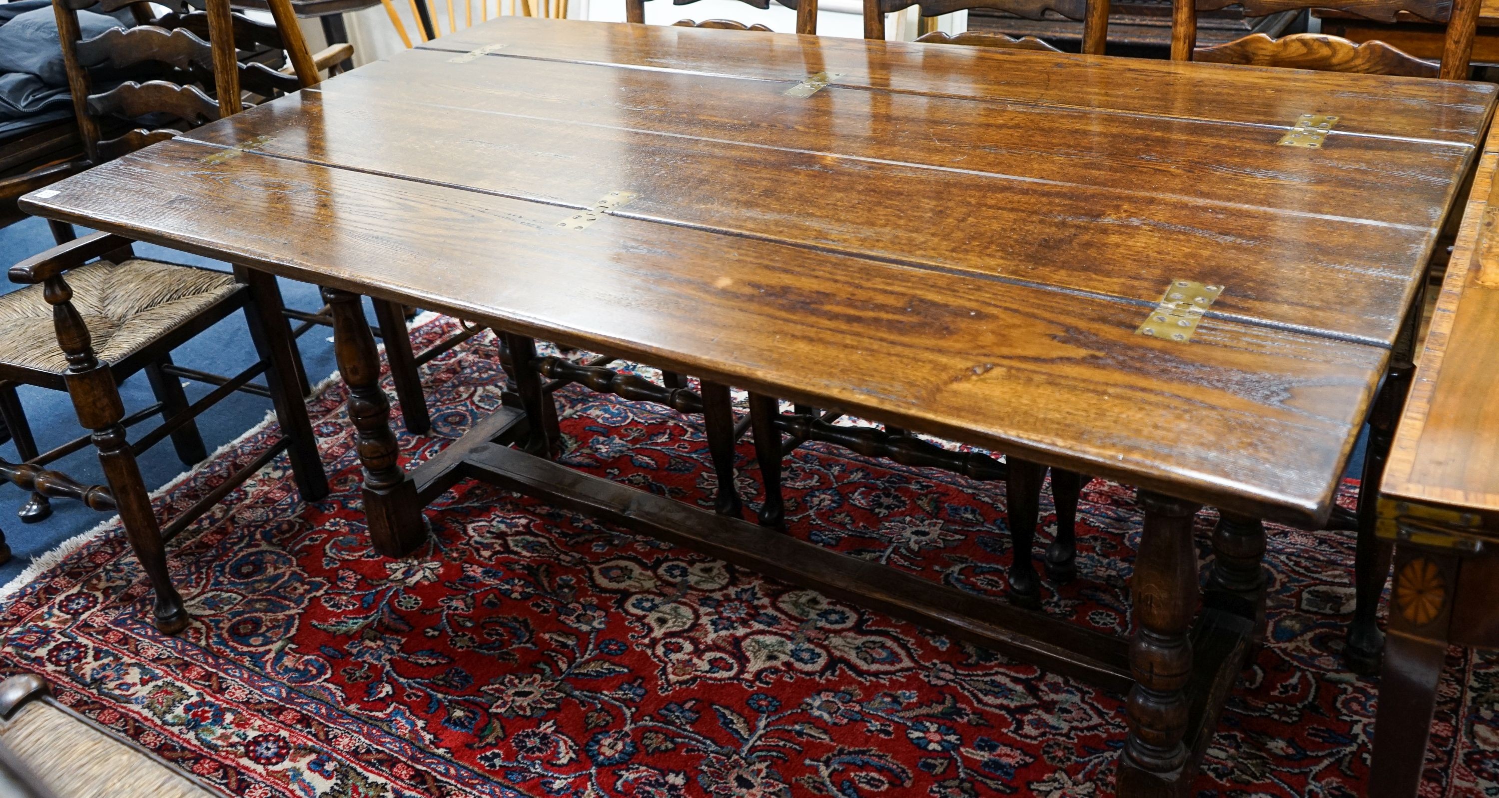 A Titchmarsh & Godwin 18th century style rectangular oak dining table with twin flap folding top, length 170cm extended, depth 99cm, height 74cm